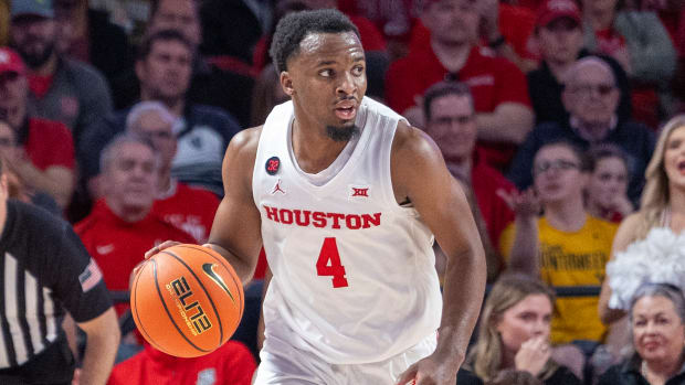 Houston guard L.J. Cryer dribbles against West Virginia